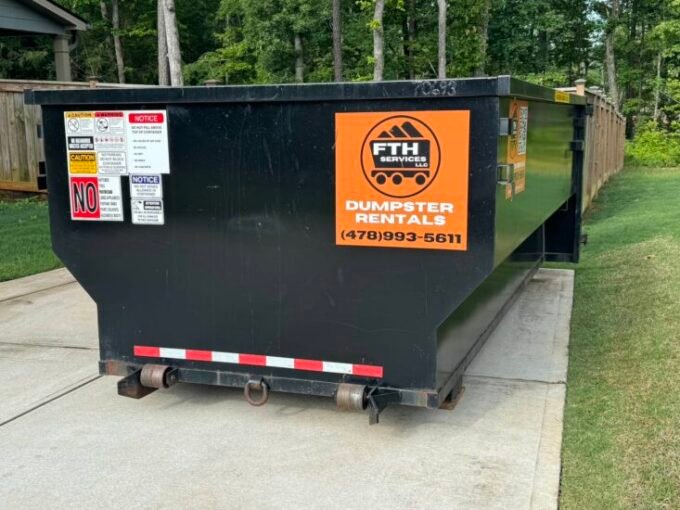 FTH Services roll-off dumpster rental on a residential site in Forsyth, GA