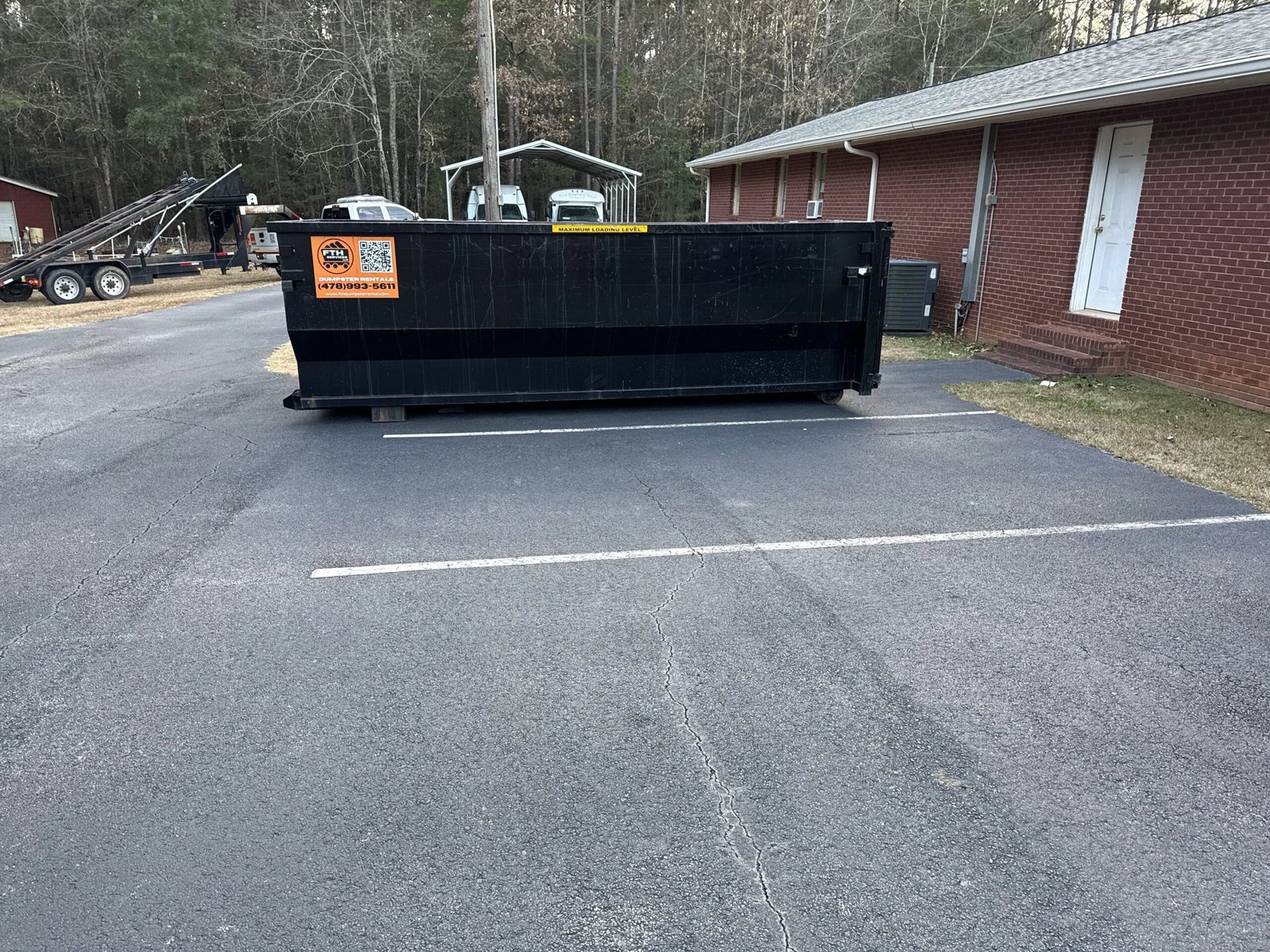 Dumpster rental in Forsyth, GA placed in a residential yard.