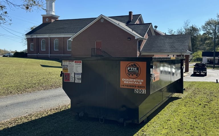 Roll off dumpster in front of a church.